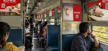 Interior train branding with QR code advertising inside an Indian Railways coach