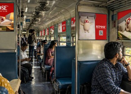 Interior train branding with QR code advertising inside an Indian Railways coach