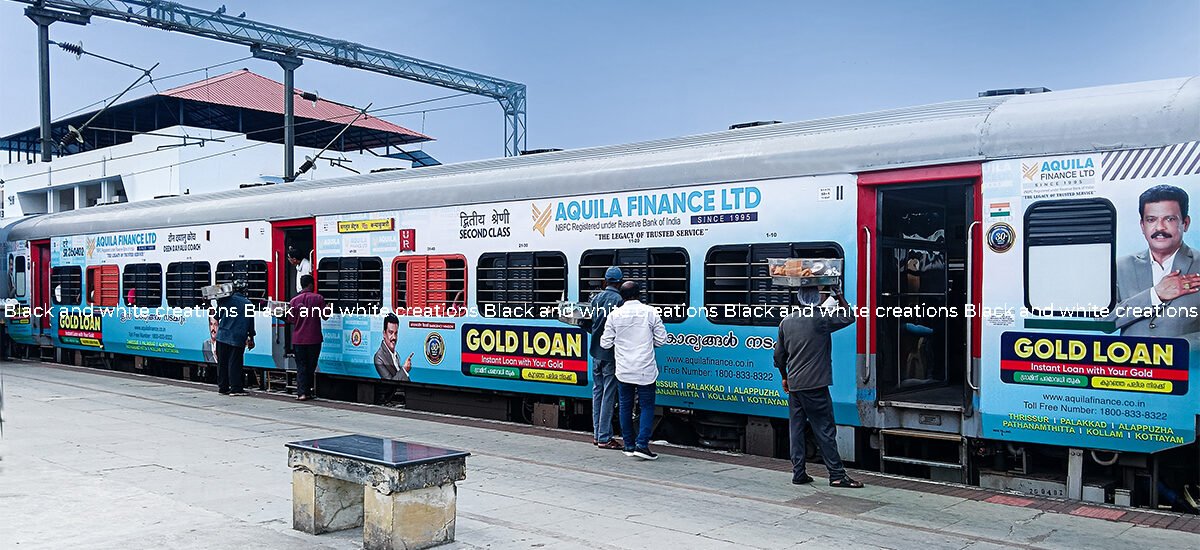 Railway advertising in India featuring a passenger train with exterior branding at a railway station.