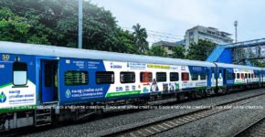 Railway advertising on an Indian passenger train, illustrating train branding and campaign planning costs.