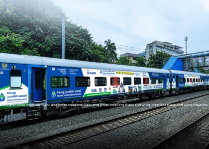 Railway advertising on an Indian passenger train, illustrating train branding and campaign planning costs.